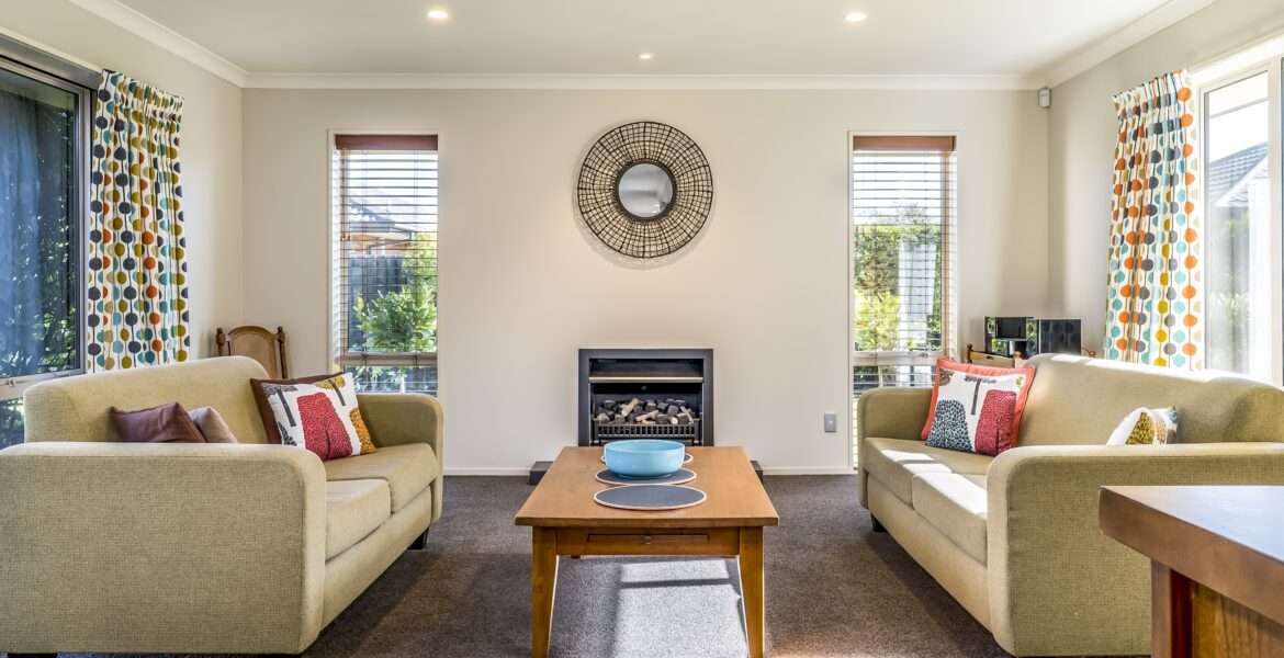 Living room of a modern apartment with two identical sofas opposite each other